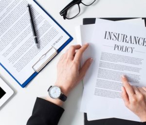 An insurance representative looking over a personal insurance policy