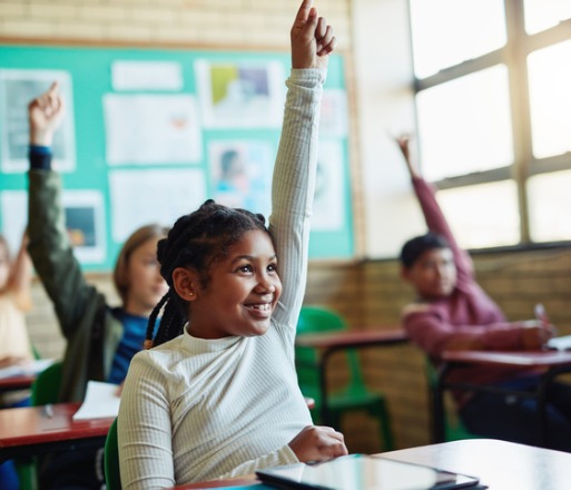 Happy students raising their hands, all covered under School insurance