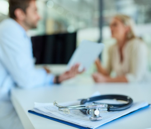 A patient with Life & Health insurance talking with her doctor